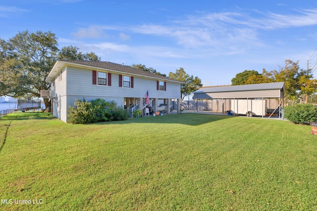 rear view of property with a lawn