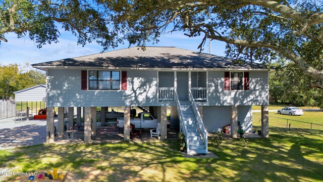 back of property featuring a patio area and a lawn