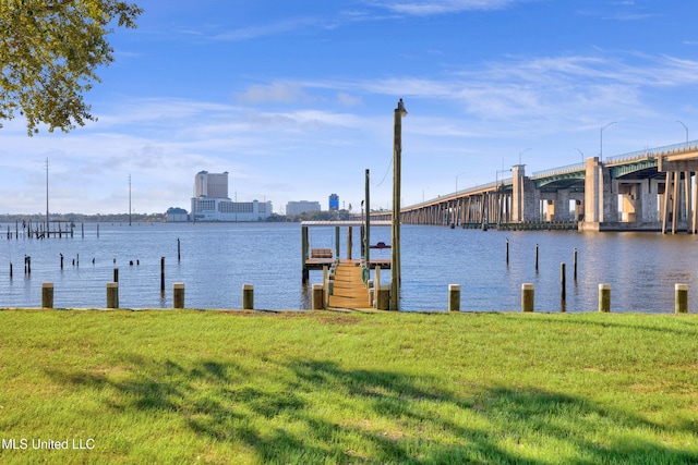 dock area featuring a water view and a yard