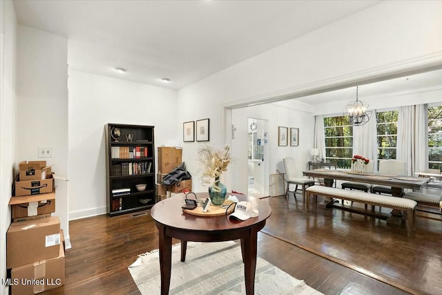 interior space featuring a chandelier and dark hardwood / wood-style floors