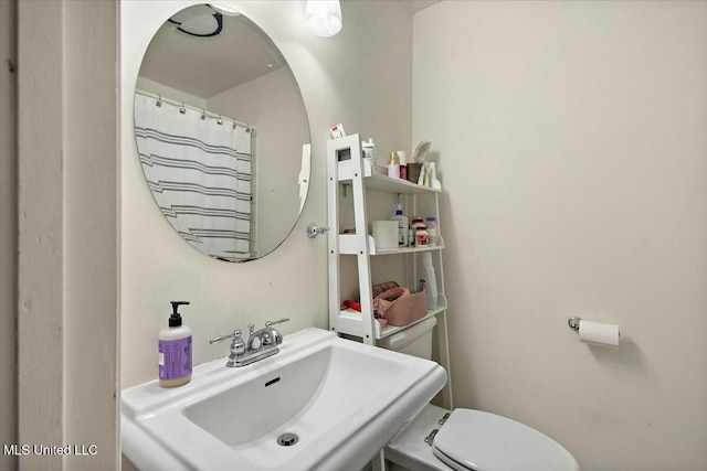 bathroom with sink and toilet