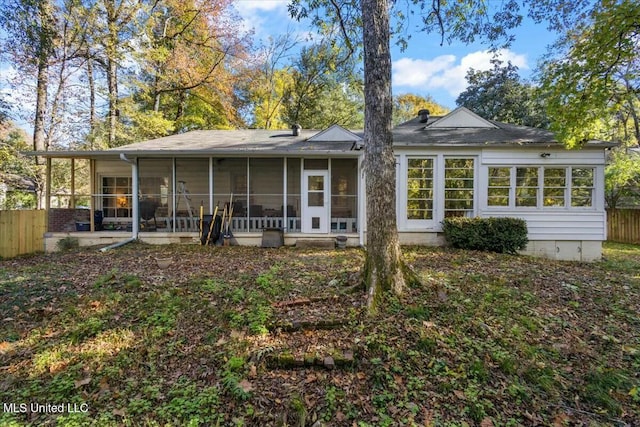 rear view of house featuring a sunroom