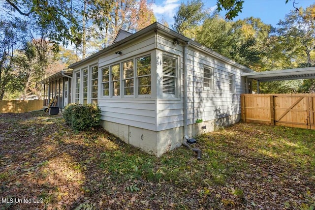 view of side of home featuring a sunroom