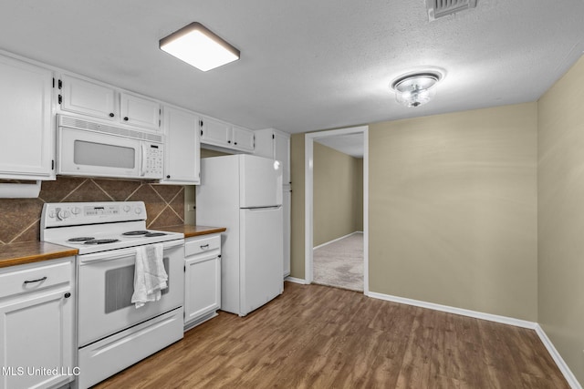 151 Lakebend Cir, Brandon, MS 39042 - kitchen with white appliances, wood finished floors, white cabinetry, backsplash, and dark countertops