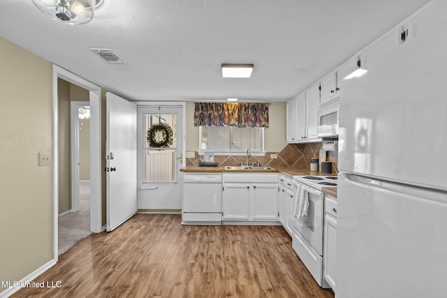 151 Lakebend Cir, Brandon, MS 39042 - kitchen with white appliances, wood finished floors, white cabinetry, and tasteful backsplash