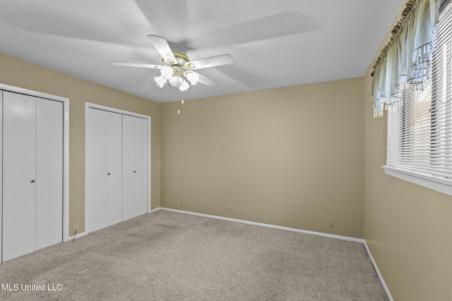 151 Lakebend Cir, Brandon, MS 39042 - unfurnished bedroom featuring two closets, carpet flooring, and ceiling fan