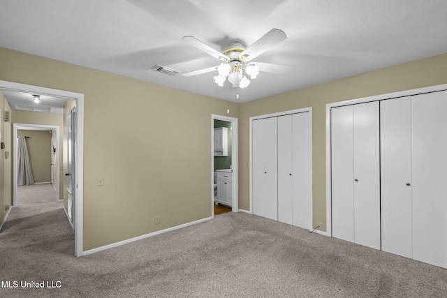 151 Lakebend Cir, Brandon, MS 39042 - unfurnished bedroom with carpet, multiple closets, a ceiling fan, and ensuite bath