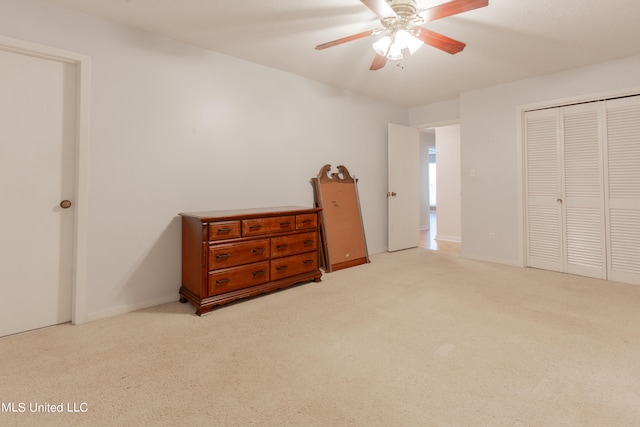 bedroom featuring light carpet, a closet, and ceiling fan