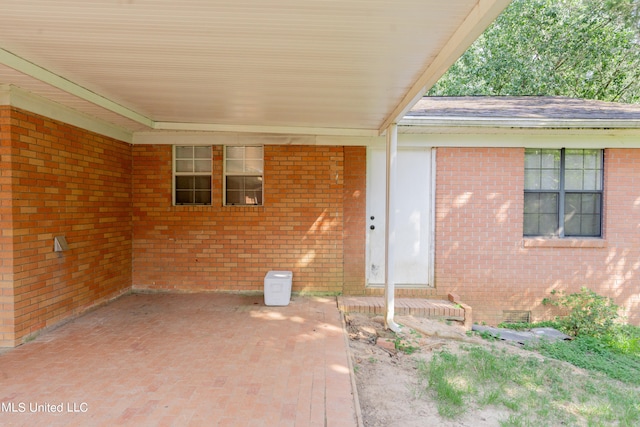 view of exterior entry featuring a patio