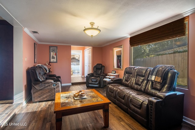 living room with crown molding, a healthy amount of sunlight, and hardwood / wood-style floors