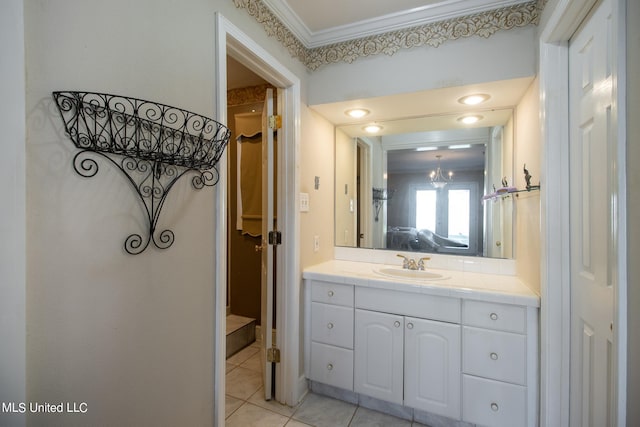 bathroom featuring vanity, ornamental molding, a chandelier, and tile patterned flooring