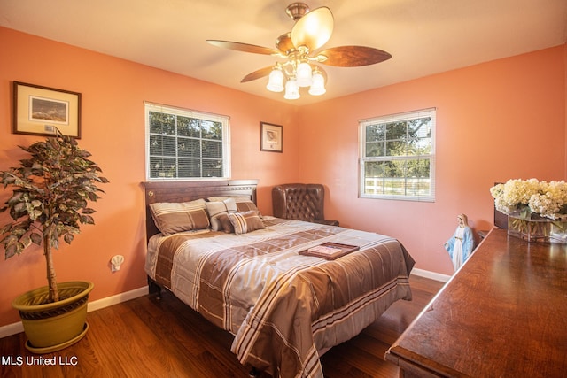 bedroom with dark hardwood / wood-style floors and ceiling fan