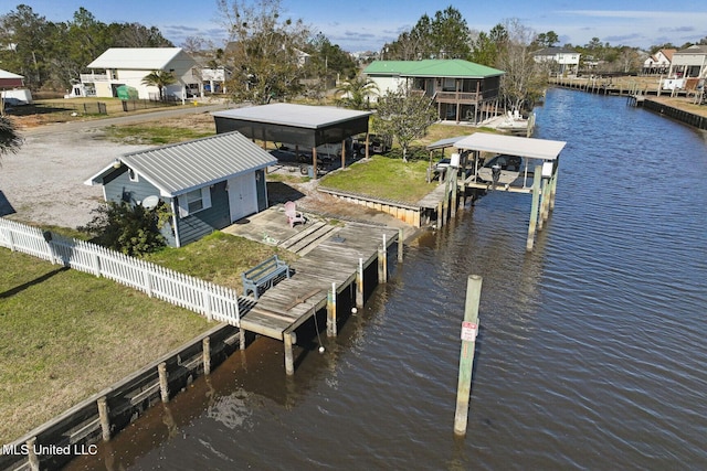 dock area with a water view and a lawn