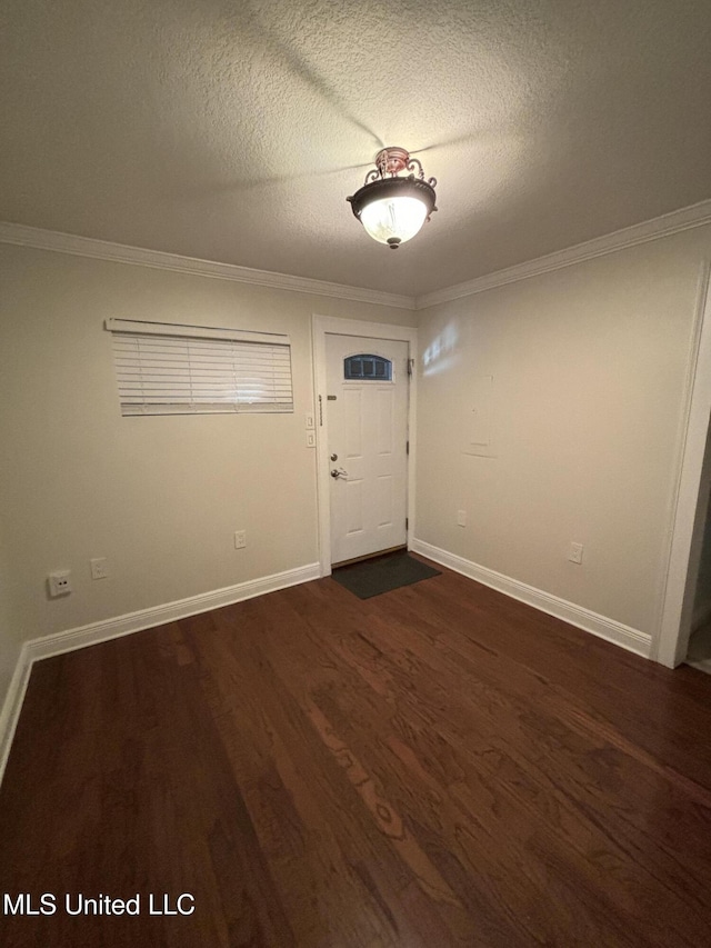 entryway featuring crown molding, dark hardwood / wood-style flooring, and a textured ceiling