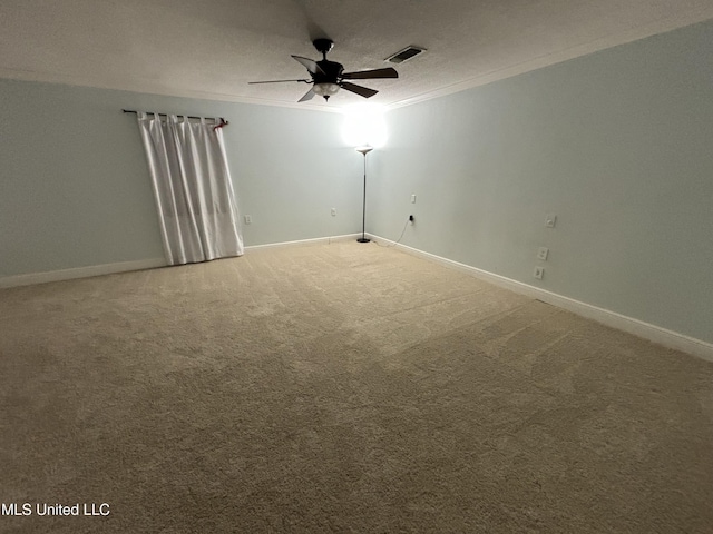 spare room featuring carpet, ceiling fan, crown molding, and a textured ceiling