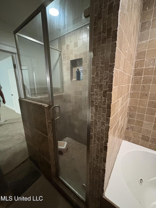 bathroom featuring independent shower and bath