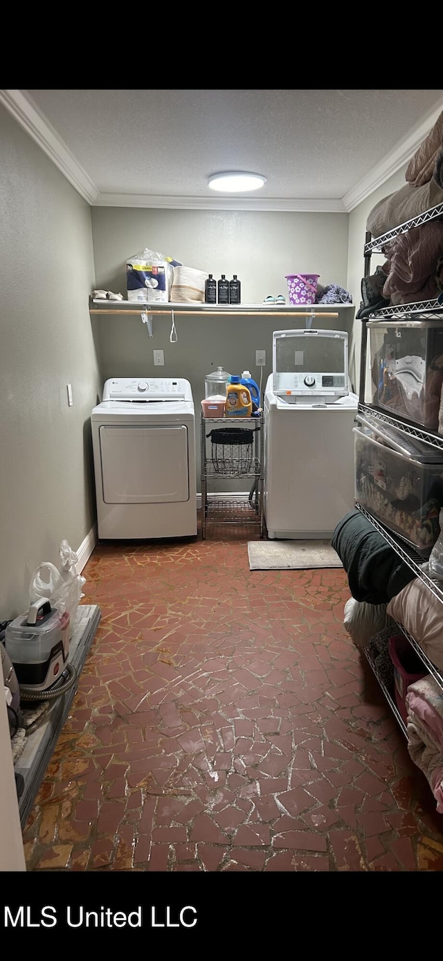 laundry area featuring separate washer and dryer and ornamental molding