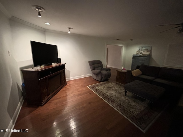 living room featuring ceiling fan and dark hardwood / wood-style floors