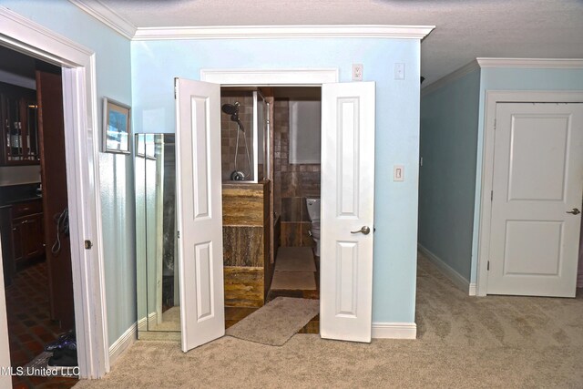 bedroom with carpet flooring, ornamental molding, and a textured ceiling