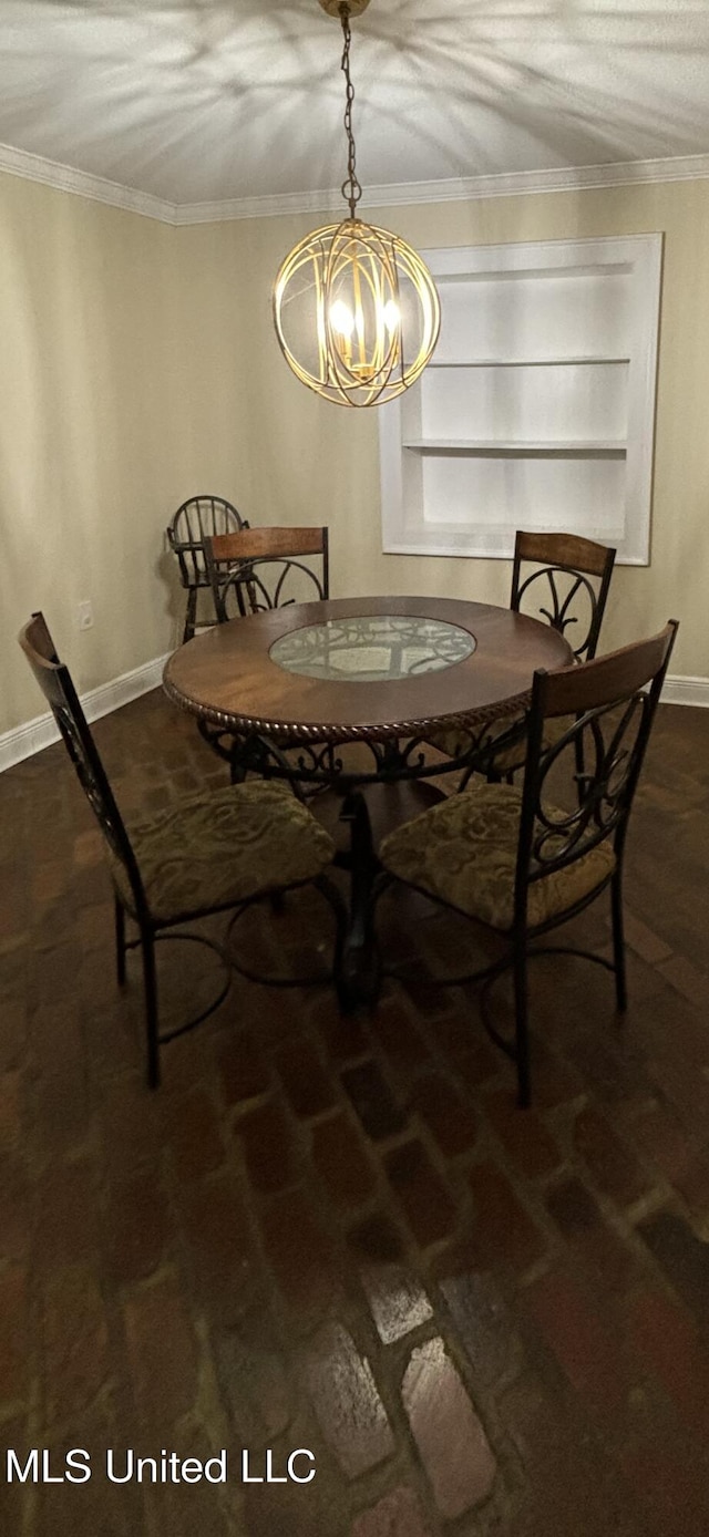 carpeted dining space with crown molding and an inviting chandelier