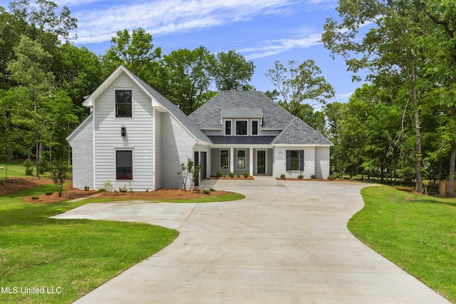 231 Oakside Trl, Madison, MS 39110 - view of front of home with curved driveway, a front lawn, and a shingled roof