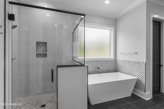 231 Oakside Trl, Madison, MS 39110 - bathroom with a freestanding bath, a stall shower, tile patterned flooring, wainscoting, and recessed lighting