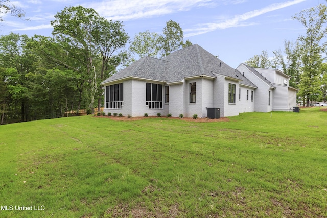 231 Oakside Trl, Madison, MS 39110 - rear view of house featuring central AC unit, a yard, brick siding, and roof with shingles