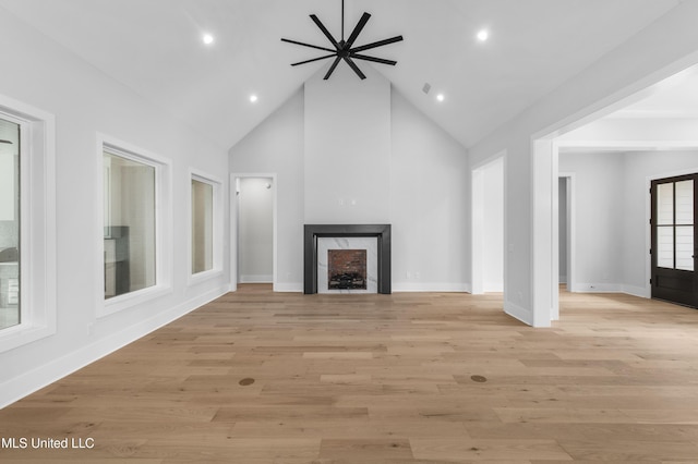 231 Oakside Trl, Madison, MS 39110 - unfurnished living room with high vaulted ceiling, a fireplace, baseboards, recessed lighting, and light wood-style flooring