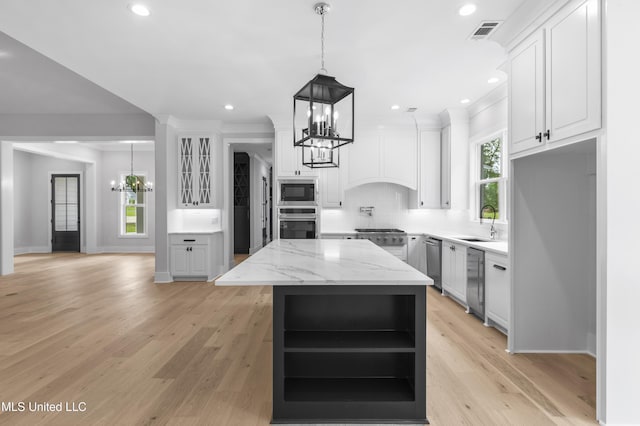 231 Oakside Trl, Madison, MS 39110 - kitchen featuring a chandelier, appliances with stainless steel finishes, open shelves, a sink, and a kitchen island