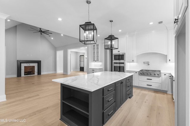 231 Oakside Trl, Madison, MS 39110 - kitchen with stainless steel appliances, white cabinetry, a kitchen island, tasteful backsplash, and recessed lighting