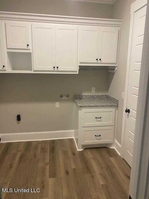 clothes washing area featuring dark wood-type flooring