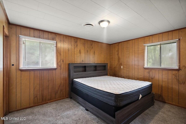 308 Asbury Dr, Hazlehurst, MS 39083 - carpeted bedroom with wooden walls and baseboards