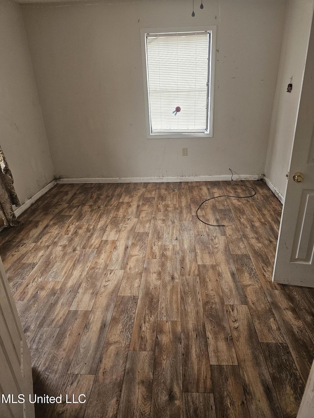 219 W St, Batesville, MS 38606 - unfurnished room with dark wood-type flooring