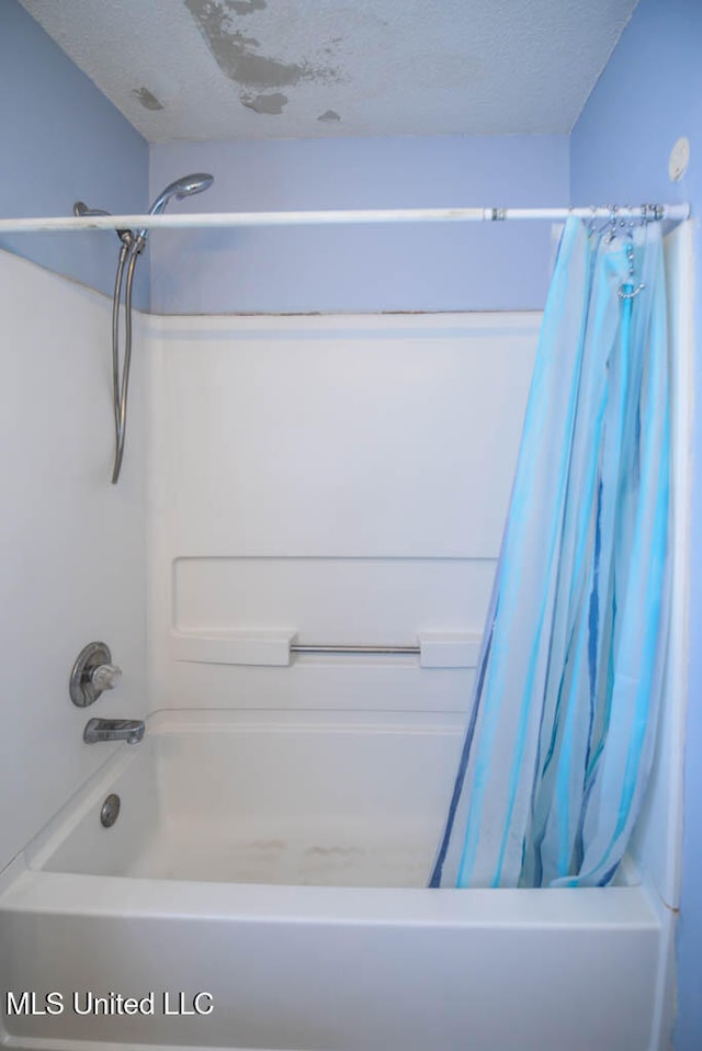 796 Steward Ln, Southaven, MS 38671 - bathroom with a textured ceiling and shower / bathtub combination with curtain