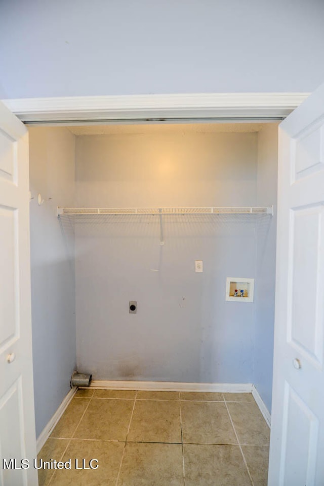 796 Steward Ln, Southaven, MS 38671 - clothes washing area featuring hookup for an electric dryer, washer hookup, light tile patterned floors, and baseboards