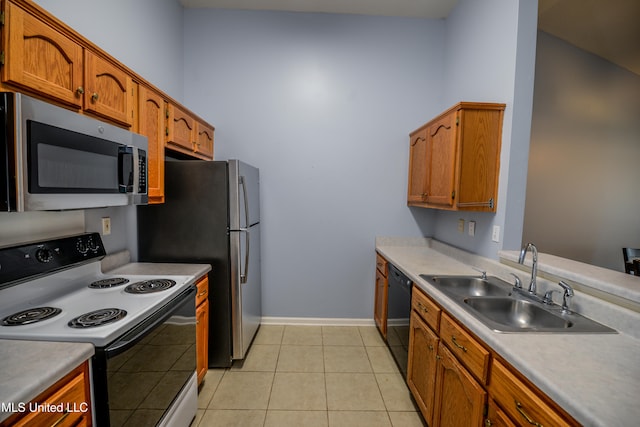 796 Steward Ln, Southaven, MS 38671 - kitchen featuring stainless steel microwave, electric stove, a sink, dishwasher, and brown cabinets