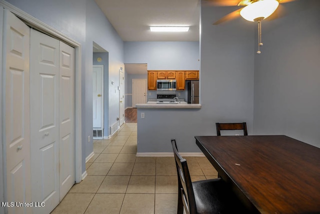 796 Steward Ln, Southaven, MS 38671 - dining area featuring light tile patterned floors, a ceiling fan, and baseboards