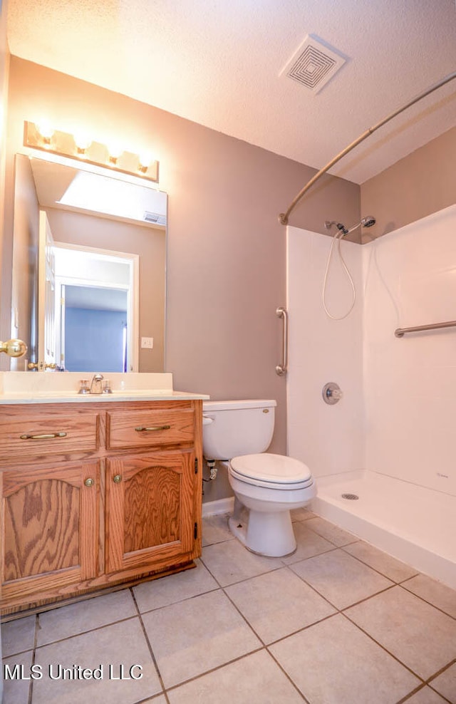 796 Steward Ln, Southaven, MS 38671 - full bathroom with a shower, toilet, tile patterned flooring, vanity, and a textured ceiling