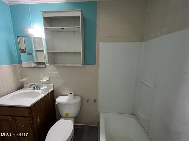 bathroom featuring a bathtub, toilet, tile walls, and vanity