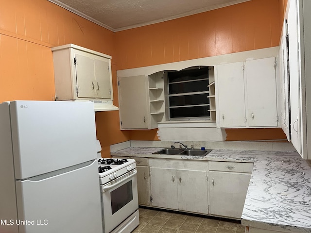 kitchen with ornamental molding, white appliances, exhaust hood, sink, and white cabinetry