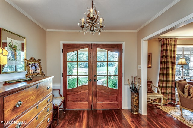 doorway to outside with french doors, crown molding, an inviting chandelier, and dark hardwood / wood-style flooring