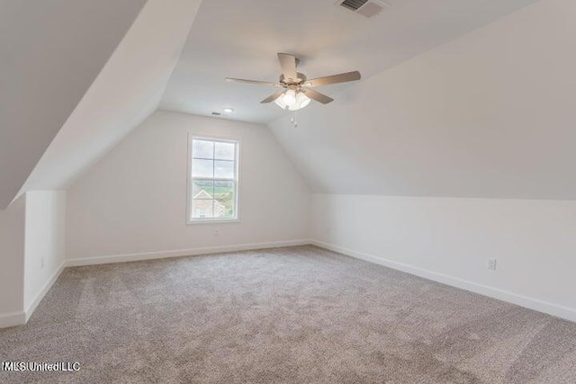 bonus room with ceiling fan, light carpet, and lofted ceiling