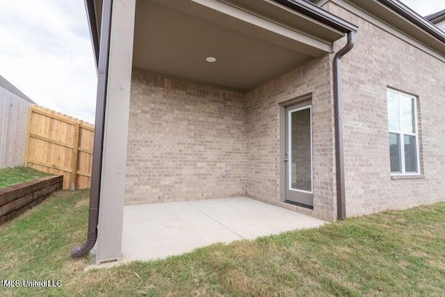 view of exterior entry featuring a patio