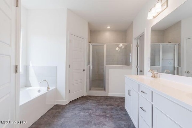 bathroom with vanity and independent shower and bath