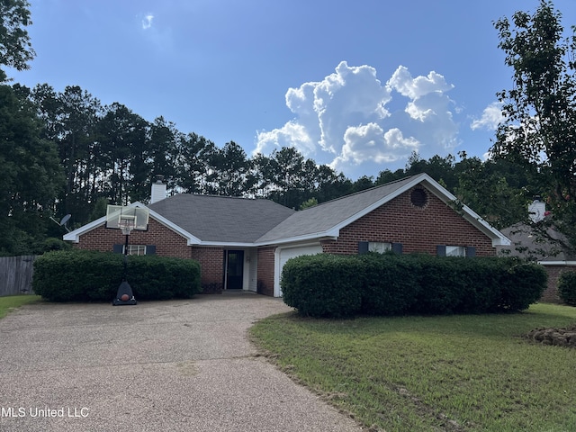 1063 Spanish Oak Dr, Pearl, MS 39208 - view of front facade with an attached garage, a front yard, a chimney, concrete driveway, and brick siding