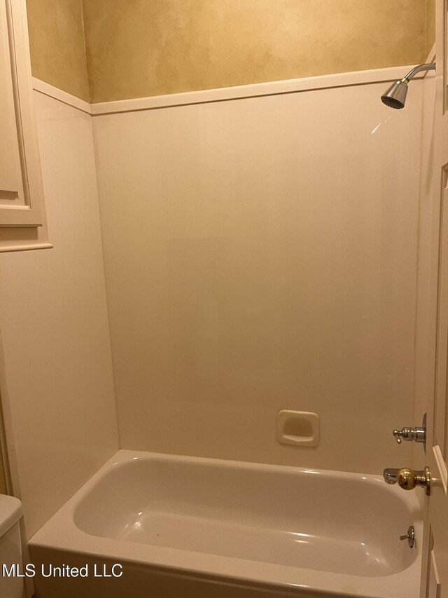 bathroom with shower / bath combination and toilet