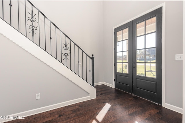 foyer with french doors and dark hardwood / wood-style flooring