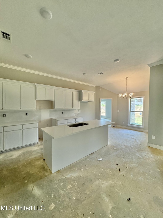 kitchen with a chandelier, a center island, white cabinetry, and sink