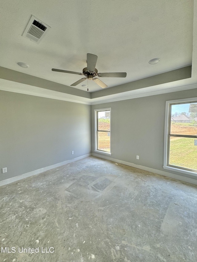 unfurnished room featuring a textured ceiling, a raised ceiling, and ceiling fan