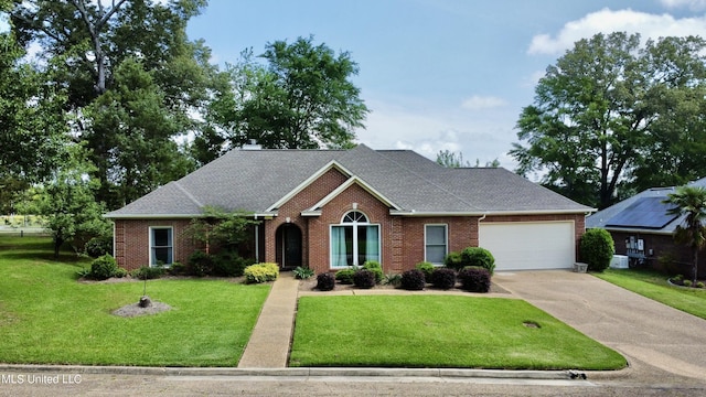 ranch-style house featuring a front lawn, brick siding, driveway, and a garage